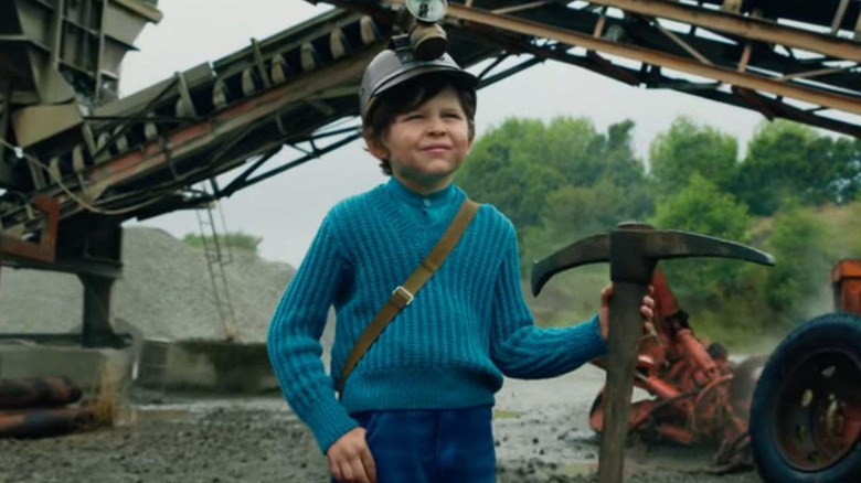 Young Steve holding a pickaxe in A Minecraft Movie