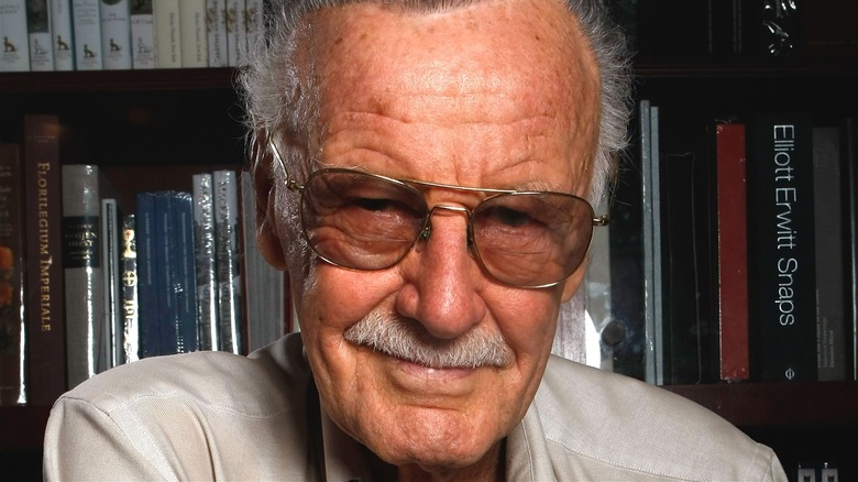 Stan Lee in front of books