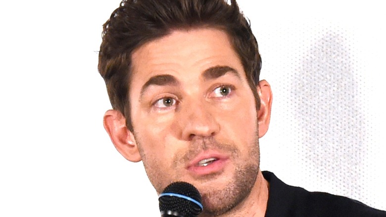 John Krasinski speaking into microphone