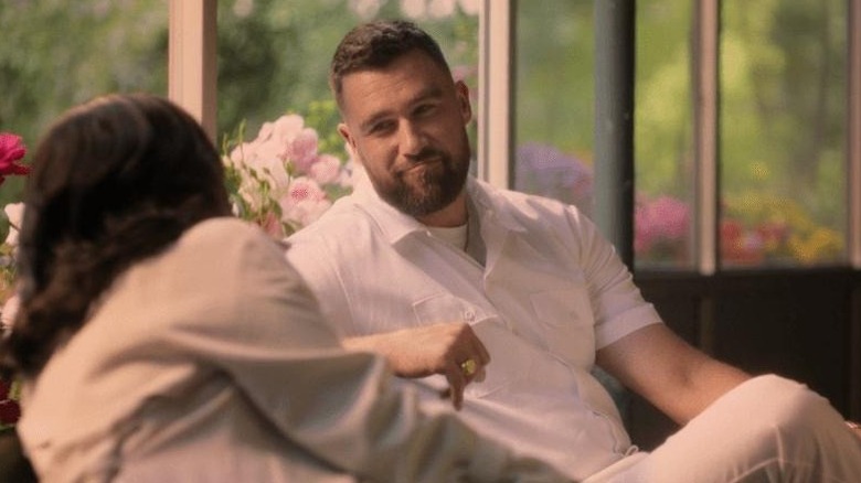 Ed sitting and talking to a woman in 
