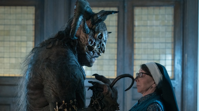 A demon stands over Sister Andrea on 