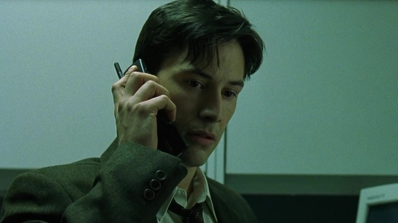 Neo talking on cell phone