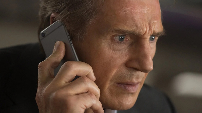 Liam Neeson talking on cell phone