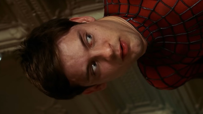 Peter Parker stuck to the ceiling looking off camera