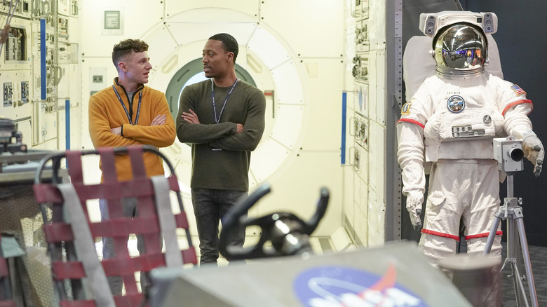 Jacob and Gregory next to each other in space museum