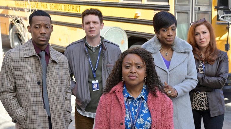 Abbott teachers standing next to bus