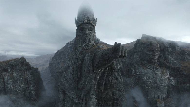Baylan standing atop the fist of a mountain-sized sculpture that depicts The Father in Ahsoka