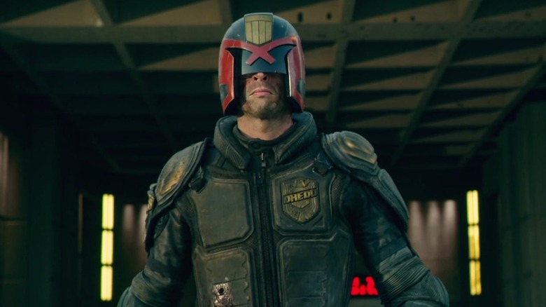 Dredd walking out of building