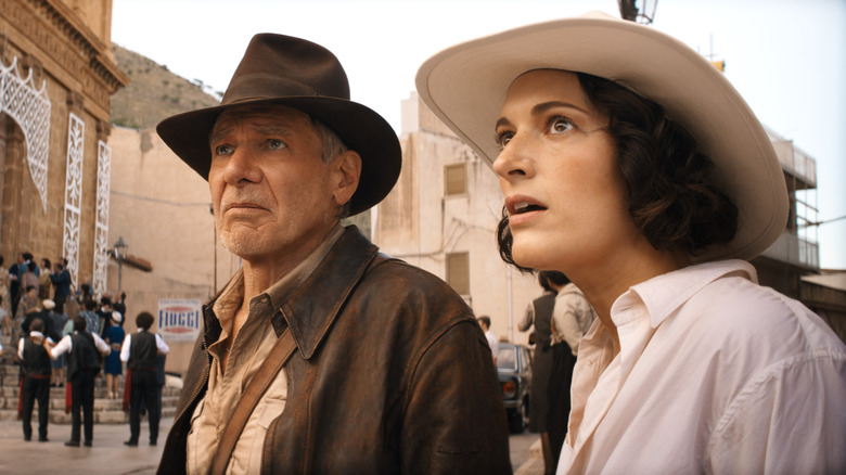 Indiana Jones and Helena walking down a city street in "Indiana Jones and the Dial of Destiny" (2023)