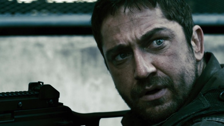 Kable looks to his side while aiming a gun in Gamer (2009)