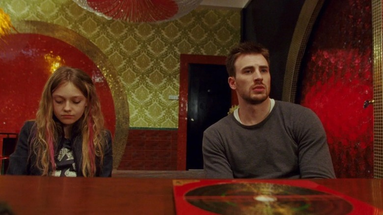 Nick Gant and Cassie Holmes sit in a colorful room in Push (2009)