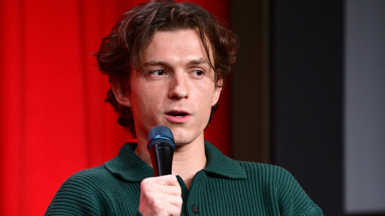 Tom Holland holding microphone