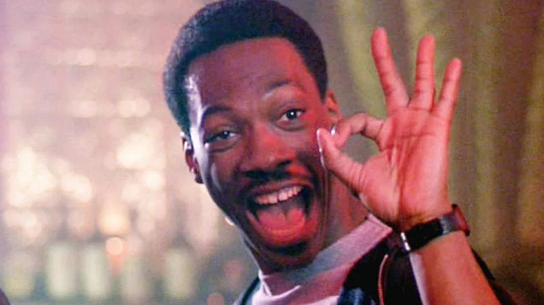 Axel Foley smiling and giving an okay with his hands