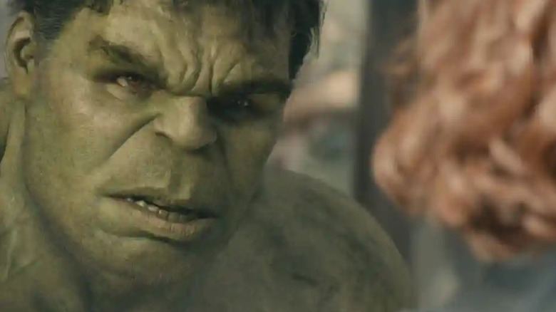 The Hulk looking at Black Widow as she talks