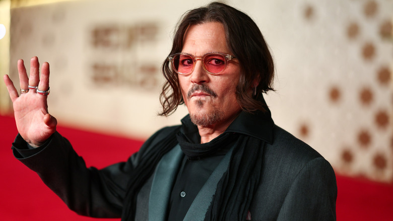 Johnny Depp waving at an event