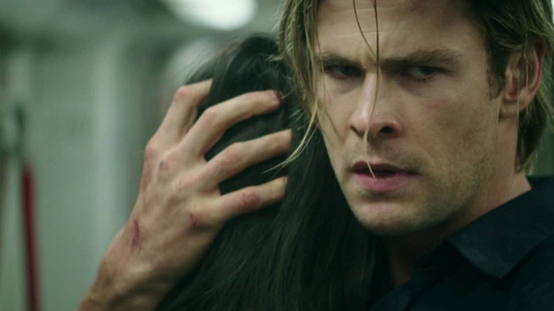 Nicholas Hathaway frowning and hugging someone in "Blackhat."