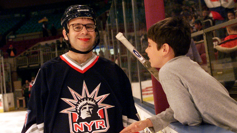 Rick Moranis smiling in ice hockey gear