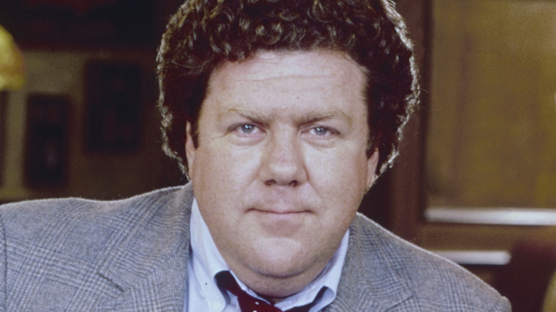 George Wendt in grey suit with red tie