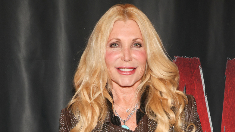 Pamela Bach smiling with curled hair