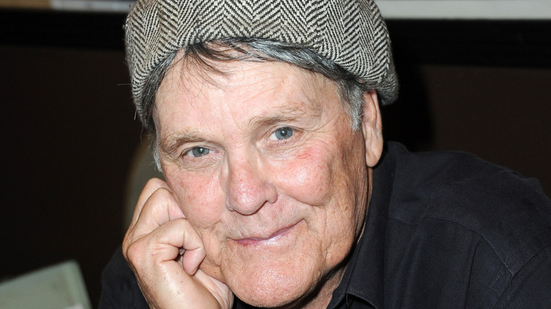 Wings Hauser posing with hat on