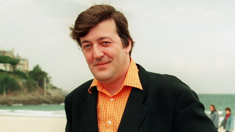 A young Stephen Fry posing outside