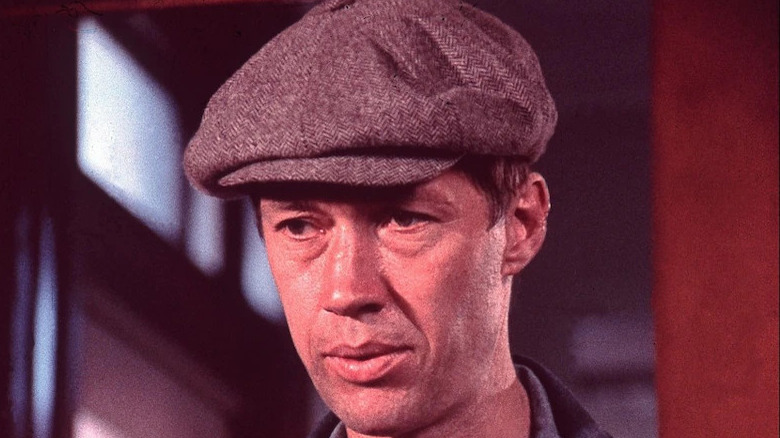 David Carradine wears a cap