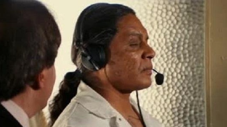 Baby Face Bob with eyes closed wearing a microphone in "The Longest Yard" (2005)
