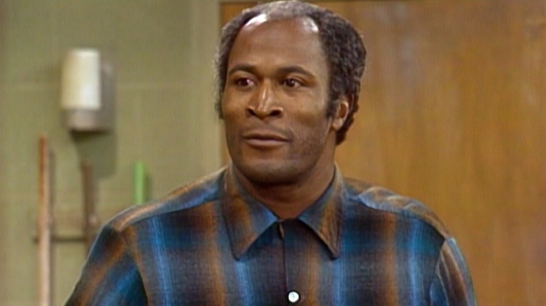 James Evans wearing a blue and orange shirt on Good Times