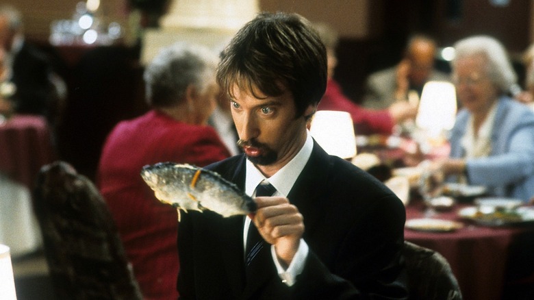 Tom Green holding fish at restaurant