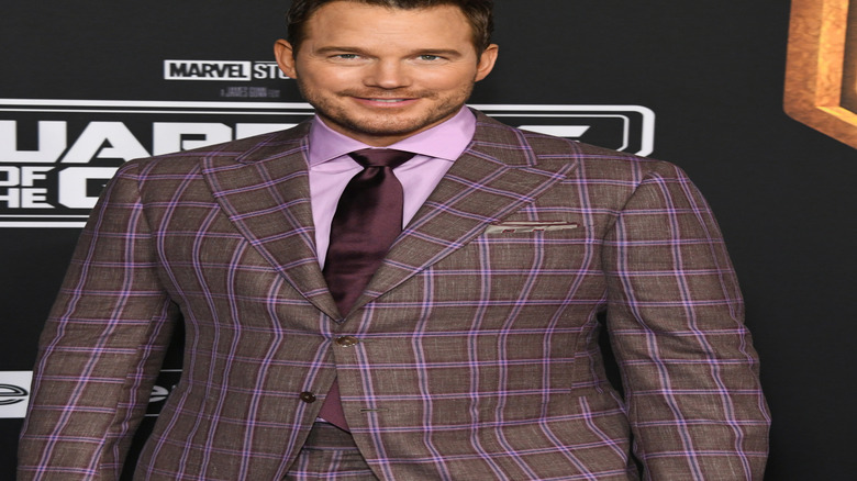 Chris Pratt smiling in purple-grey suit