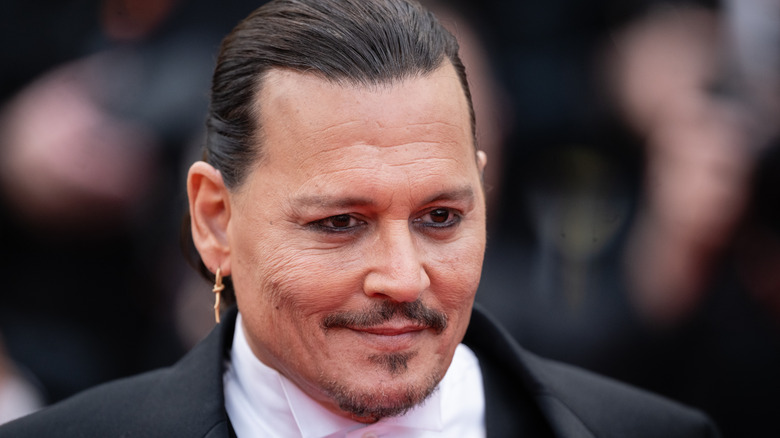 Johnny Depp smiling with hair slicked back