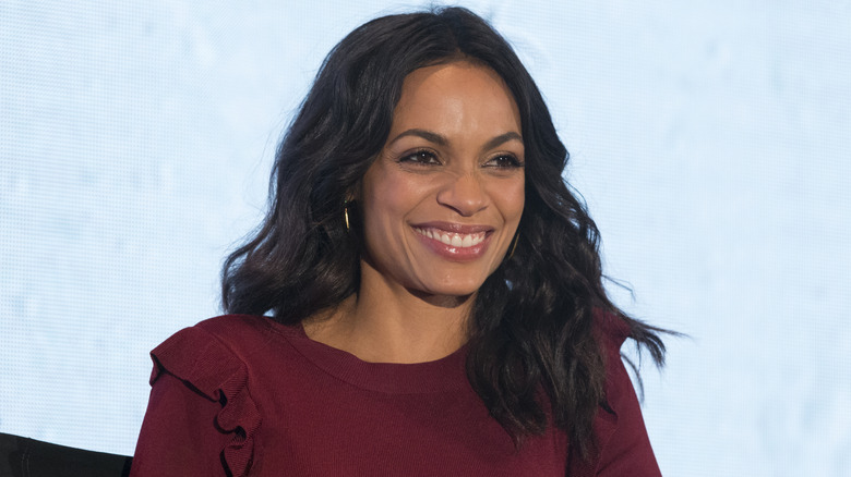 Rosario Dawson with a happy look on her face