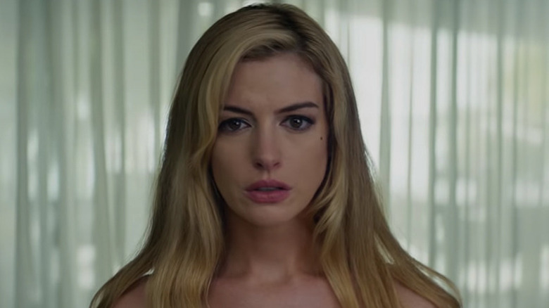 Karen stads in front of curtains