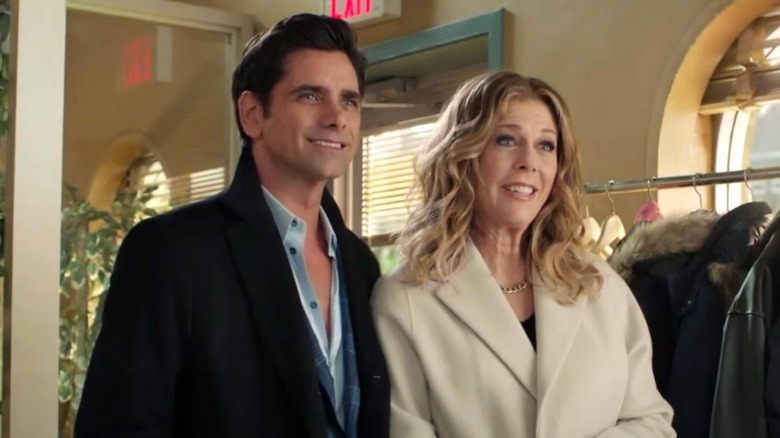 George and Anna stand in front of a coat rack in "My Big Fat Greek Wedding 2" (2016)