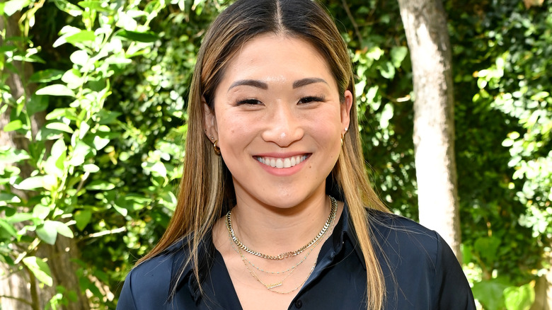 Jenna Ushkowitz standing near trees