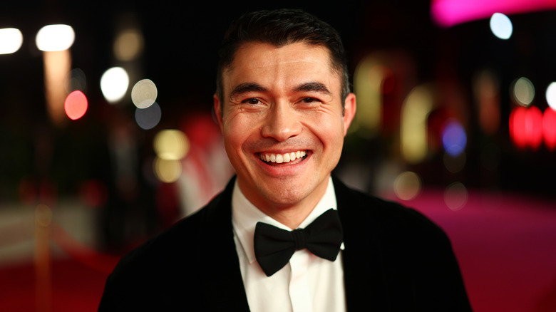 Henry Golding smiling at the Closing Night red carpet at the Red Sea International Film Festival 2025