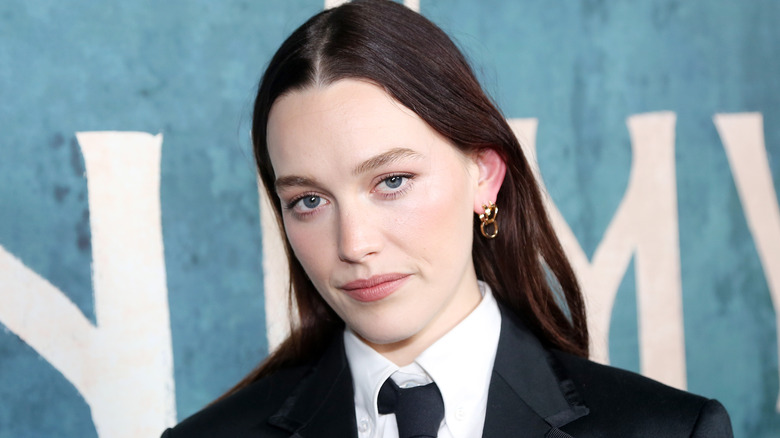 Victoria Pedretti in front of a blue background