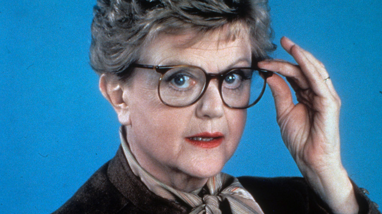 Angela Lansbury holds her glasses