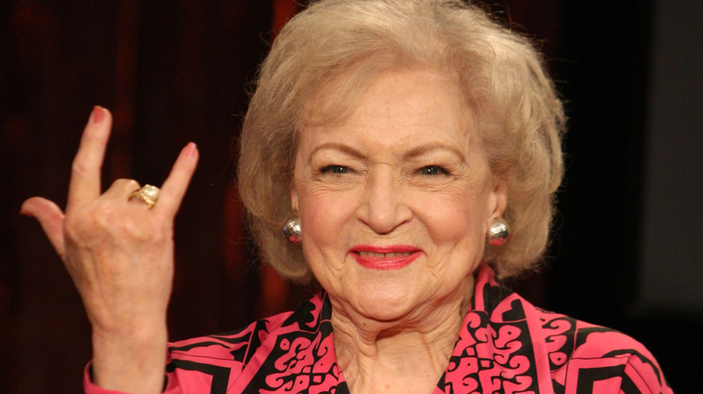 Betty White holds up devil horns