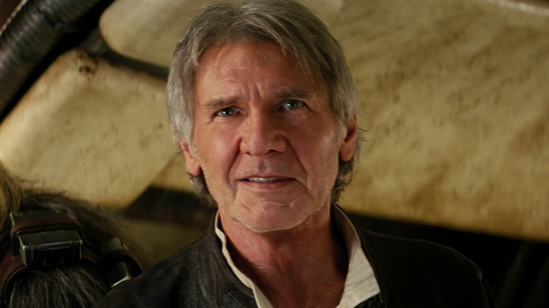 Han Solo smiling after entering the Millennium Falcon in "Star Wars: The Force Awakens"