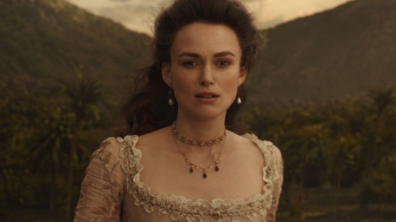 Elizabeth Swan standing in front of beach in "Pirates of the Caribbean: Dead Men Tell No Tales"