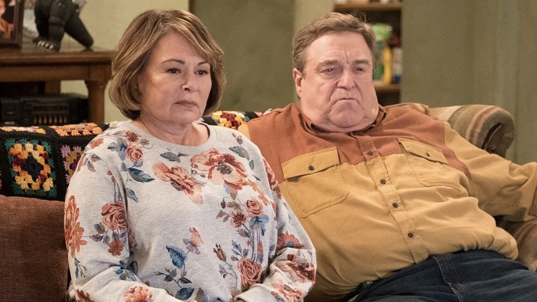 Roseanne sitting on couch with Dan