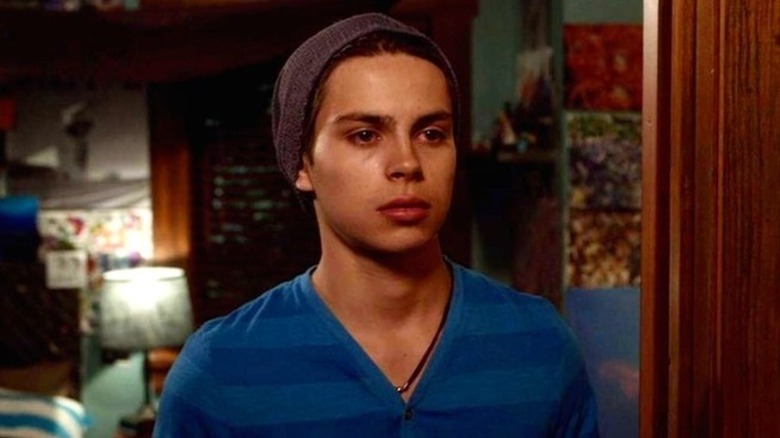 Jesus opens the door and greets an unseen person.