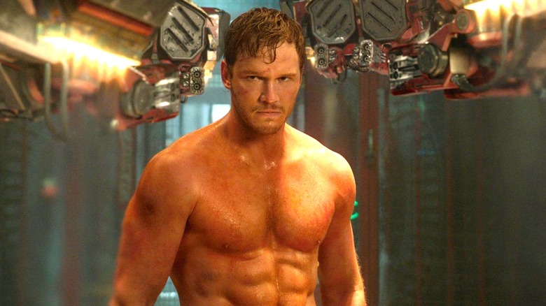 Star-Lord shirtless near robots