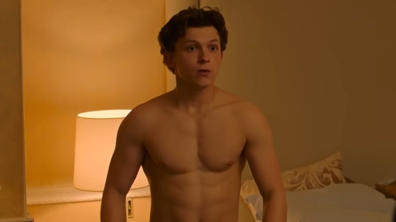 Tom Holland as Peter Parker, shirtless in a bedroom