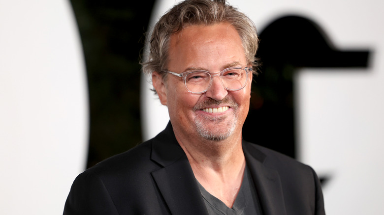 Matthew Perry smiling on red carpet