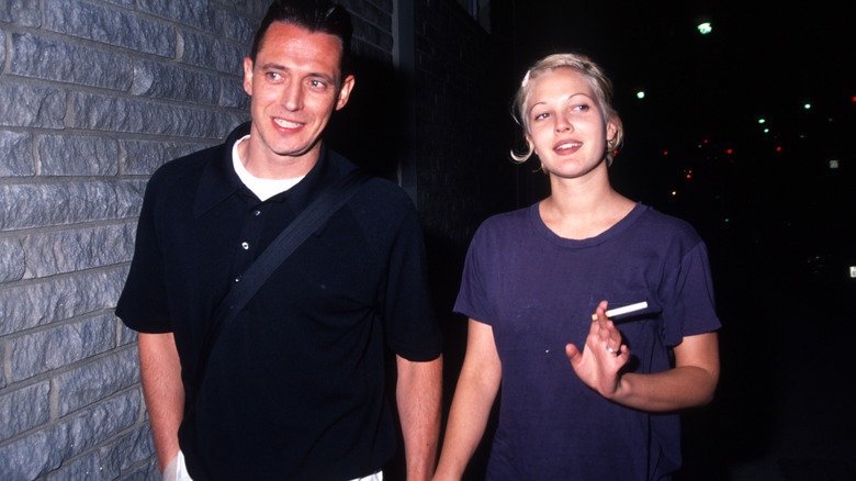 Jeremy Thomas and Drew Barrymore hold hands at the Bad Girls premiere in 1994
