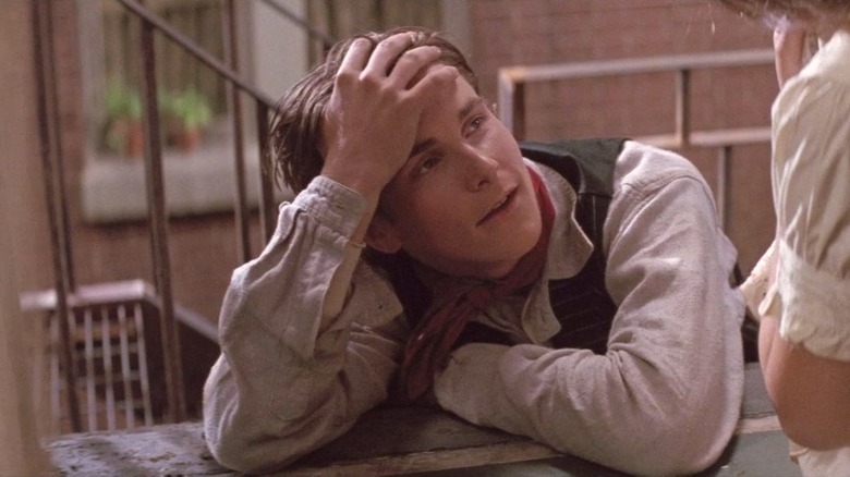 Jack "Cowboy" Kelly holding his head in "Newsies" (1992)