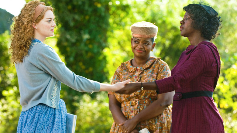 Eugenia, Minerver, and Aibileen join hands in "The Help" (2011)