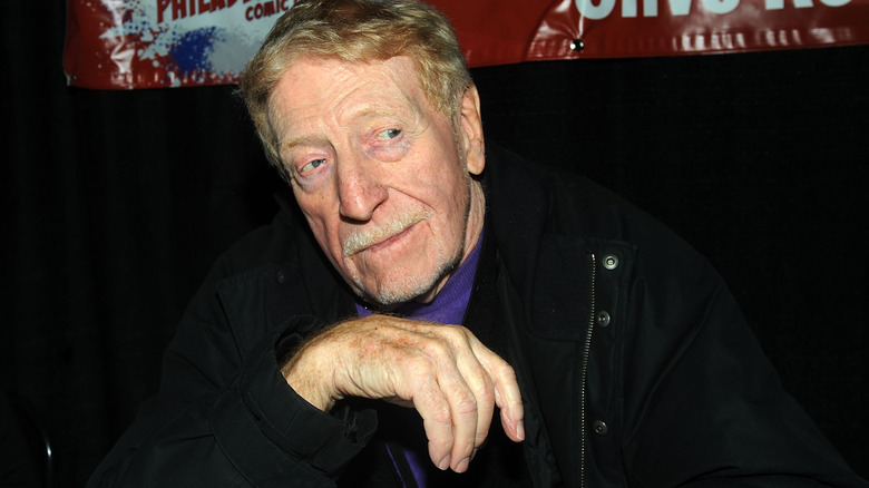 Clive Revill posing with hand by chin